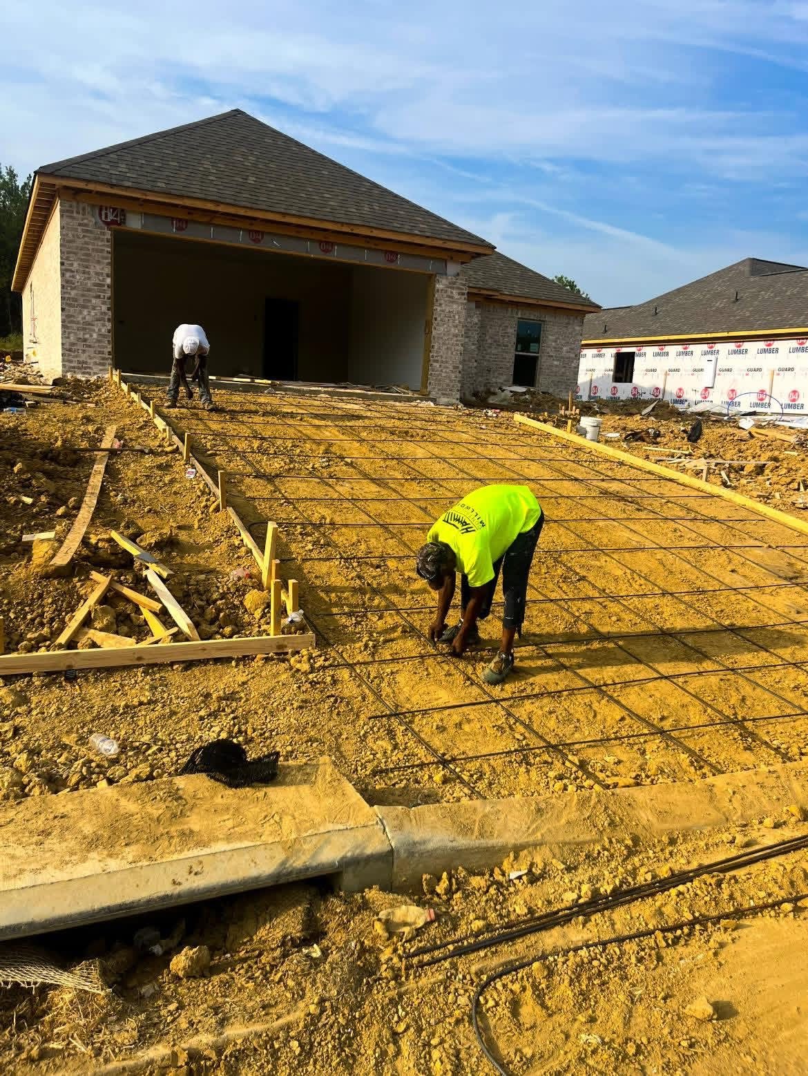 Worker preparing reinforcement outside a home
