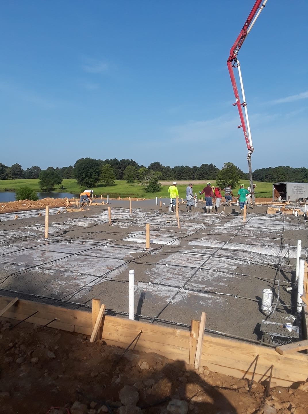 Crew preparing a concrete slab for a foundation